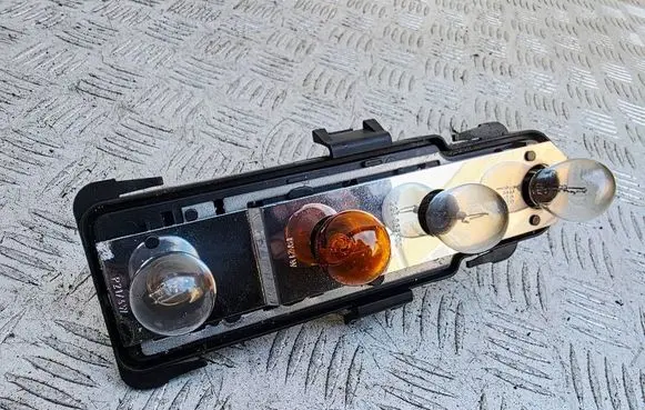 Tail light bulb cover holder