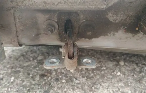 Front door check strap stopper