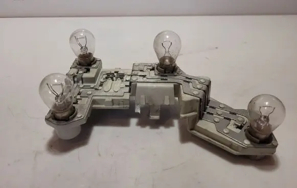 Tail light bulb cover holder
