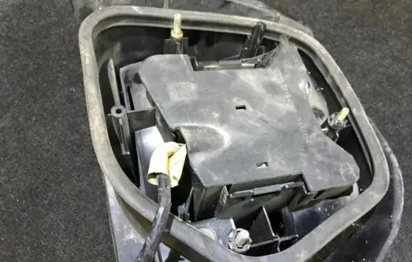 Tail light bulb cover holder