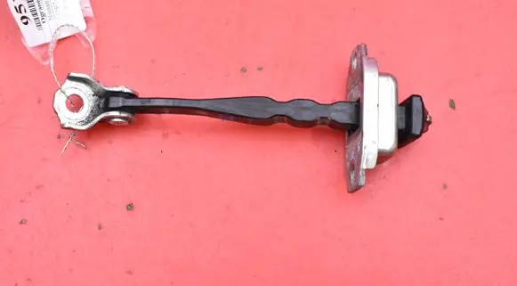 Front door check strap stopper