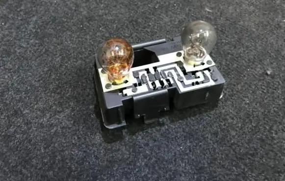 Tail light bulb cover holder