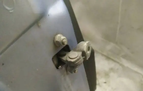 Front door check strap stopper