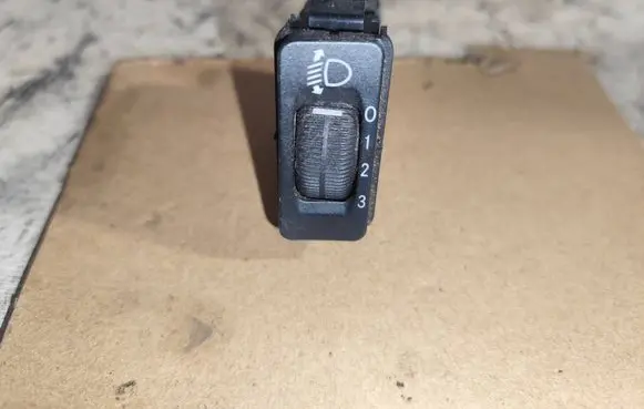 Headlight level height control switch
