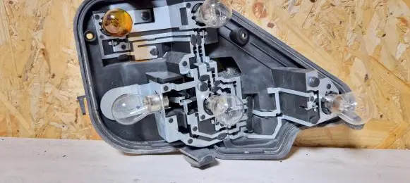 Tail light bulb cover holder