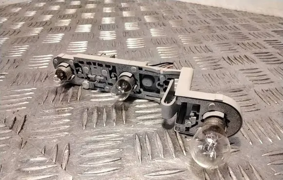 Tail light bulb cover holder