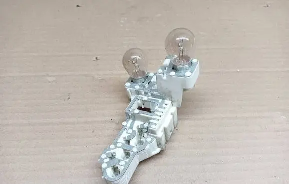 Tail light bulb cover holder
