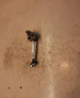 Front door check strap stopper