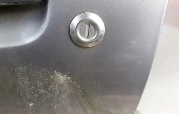 Mazda 121 Front door lock (next to the handle) 