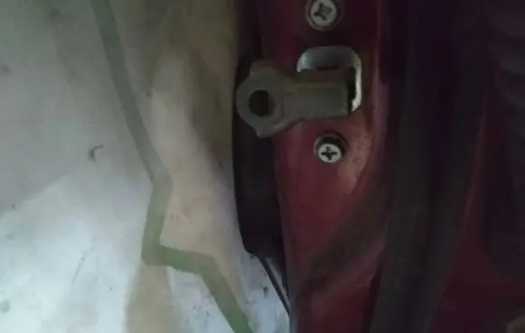 Front door check strap stopper