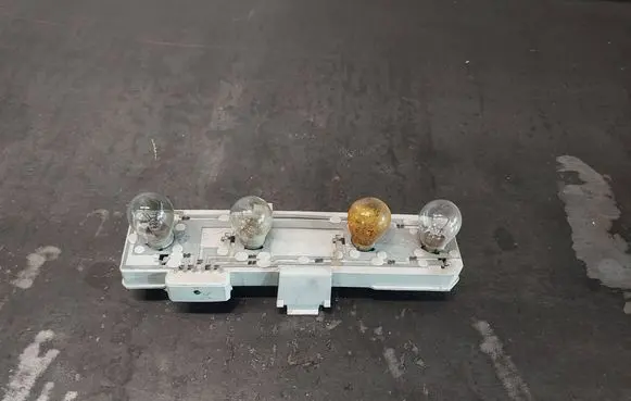 Tail light bulb cover holder