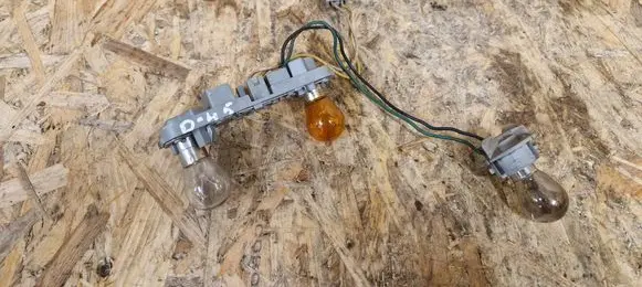 Tail light bulb cover holder