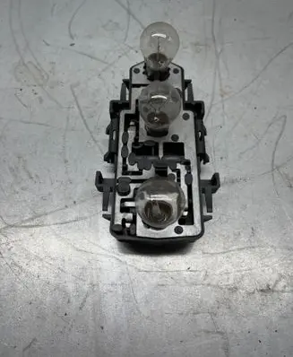 Tail light bulb cover holder