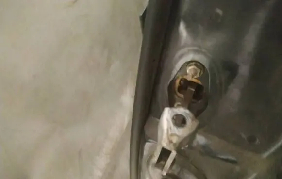 Front door check strap stopper
