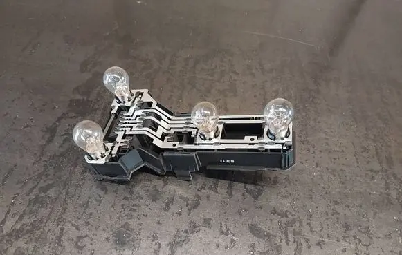 Tail light bulb cover holder