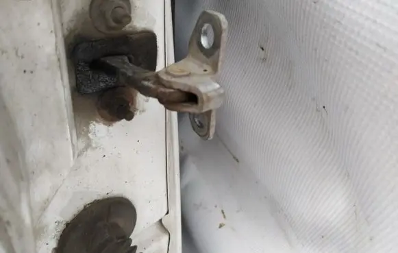 Front door check strap stopper