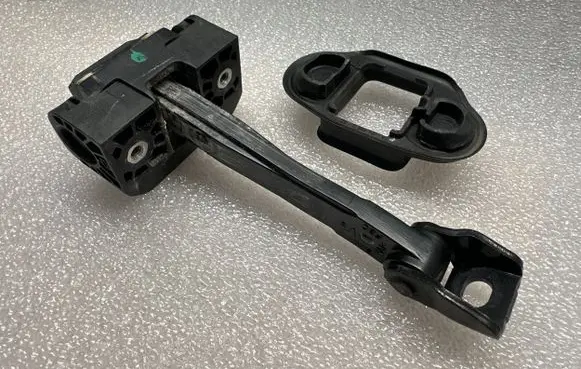 Front door check strap stopper