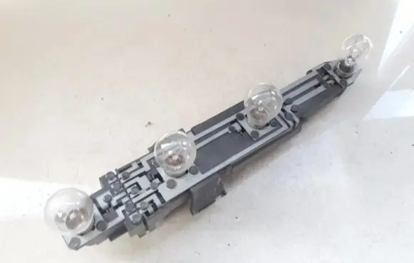 Tail light bulb cover holder