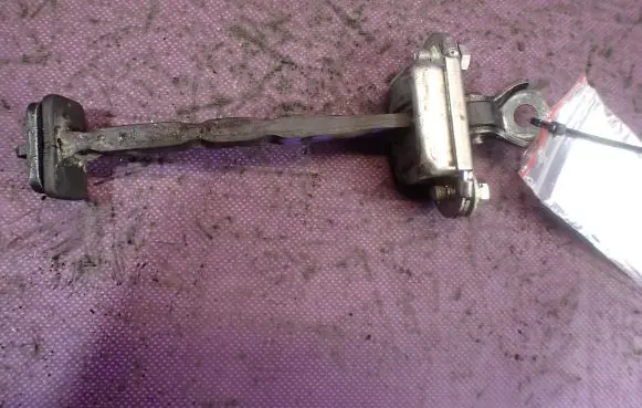 Front door check strap stopper