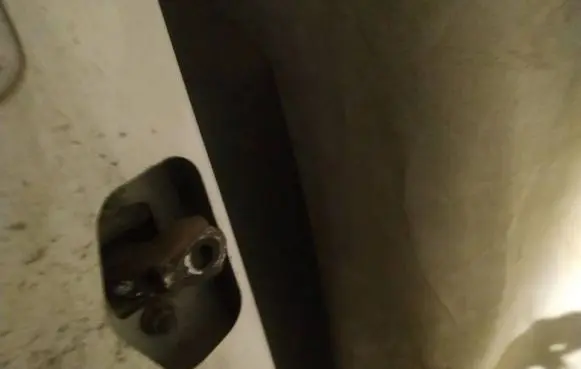 Front door check strap stopper