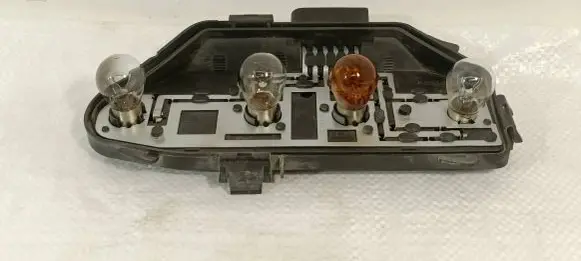 Tail light bulb cover holder
