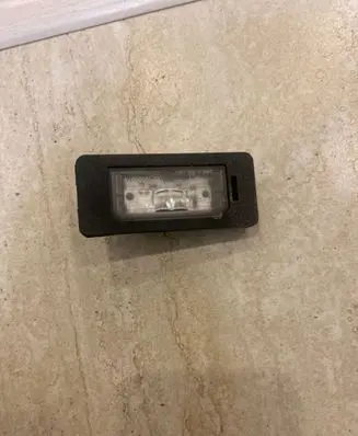 Trunk door license plate light bar