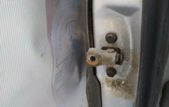 Front door check strap stopper