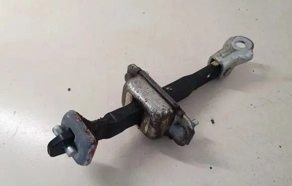 Front door check strap stopper