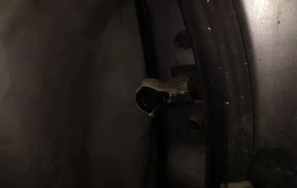 Front door check strap stopper