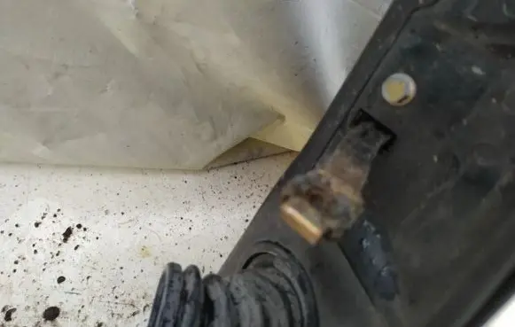 Front door check strap stopper
