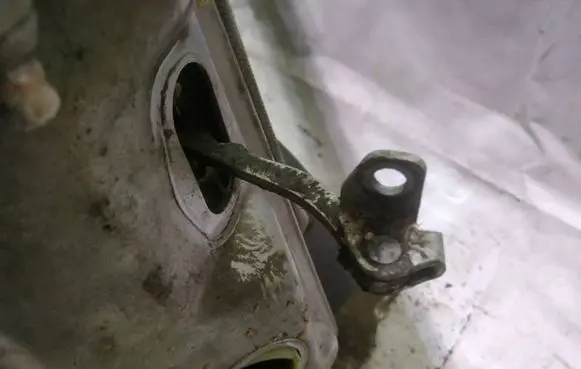 Front door check strap stopper