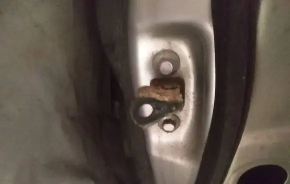 Front door check strap stopper