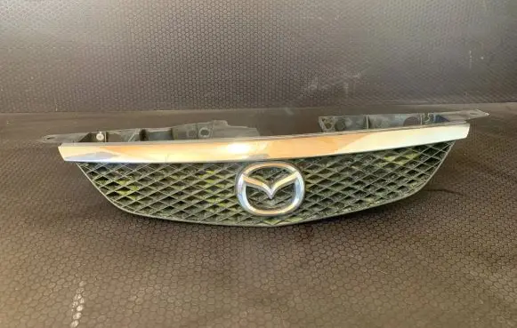 Mazda 323 Front bumper upper radiator grill