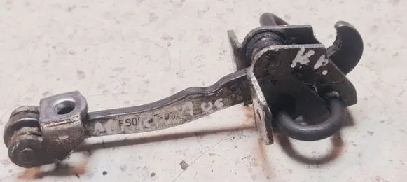 Front door check strap stopper