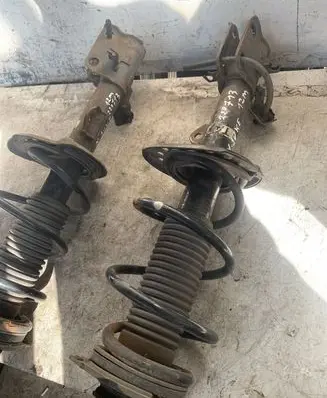 Nissan Juke I F15 Front shock absorber with coil spring