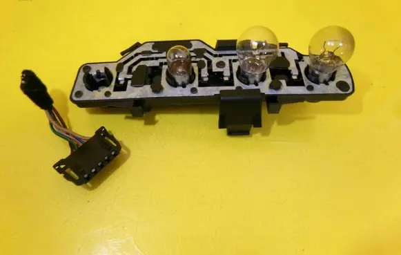 Tail light bulb cover holder