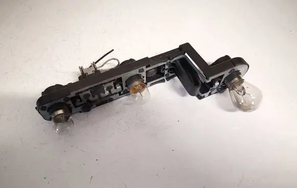 Tail light bulb cover holder