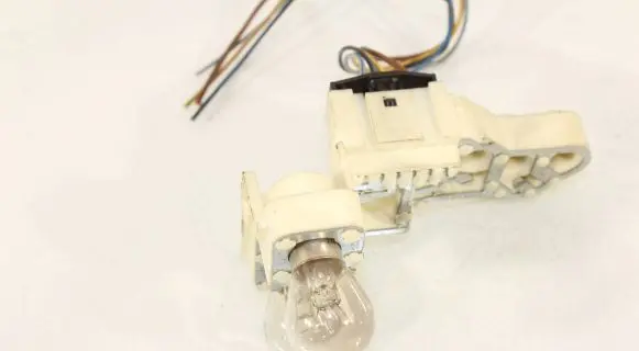 Tail light bulb cover holder