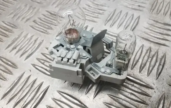 Tail light bulb cover holder