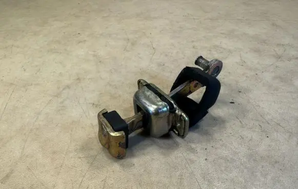 Front door check strap stopper
