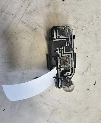 Tail light bulb cover holder