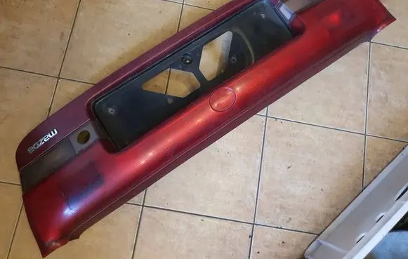 Mazda 626 Trunk door license plate light bar 0431394