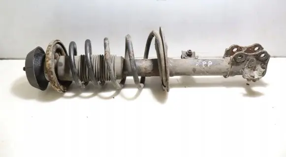 Suzuki Swift I Front shock absorber with coil spring