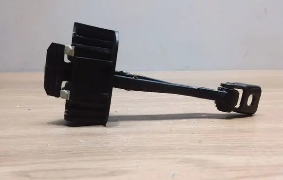 Front door check strap stopper