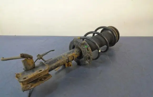 Suzuki Swift I Front shock absorber with coil spring