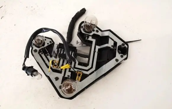 Tail light bulb cover holder