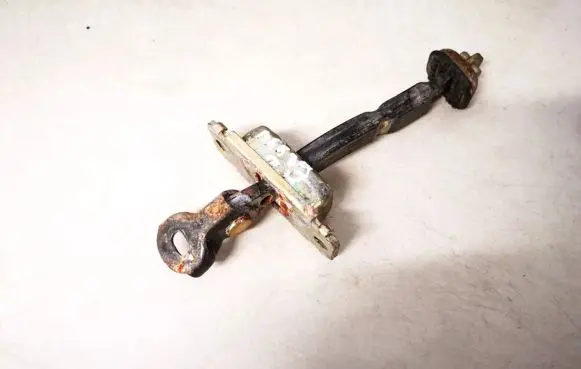 Front door check strap stopper