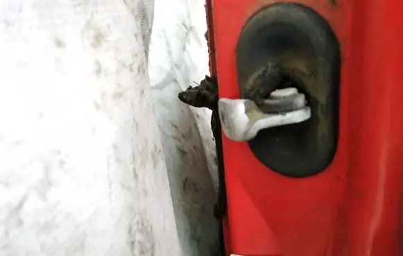 Front door check strap stopper