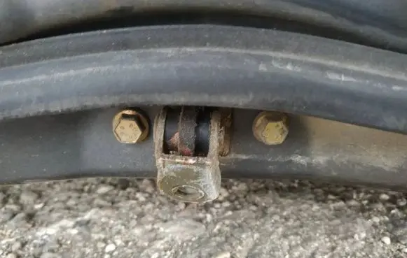 Front door check strap stopper