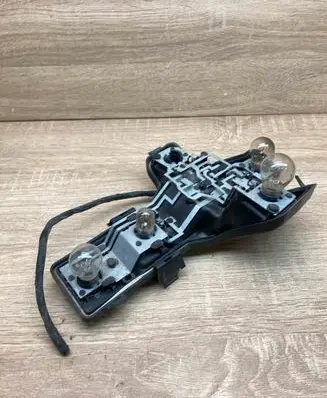 Tail light bulb cover holder